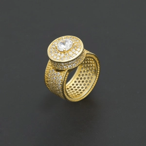 Macro shot of gold hip hop ring with large round zircon center and micro-pave crystals