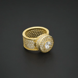 Macro view of gold hip hop ring with circular pave setting and glittering zircon stones