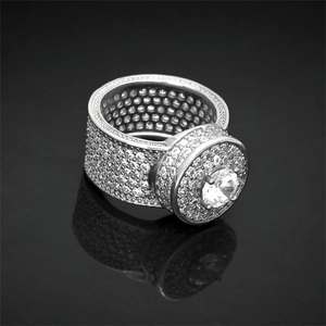 Macro shot of silver wide-band ring with dense pave zircons and large round center stone