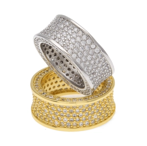 Detailed close-up of stacked gold and silver Cuban style rings with full pave setting