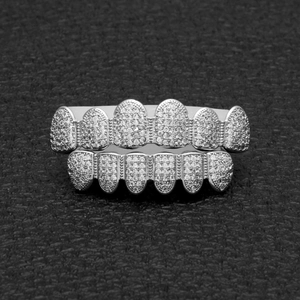 Macro shot of silver hip hop grillz set with micro-paved cubic zirconia on black leather