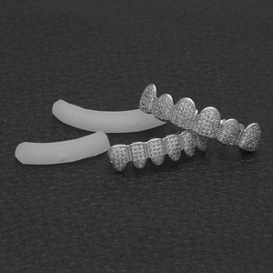 Detailed view of hip hop silver grillz set with micro-paved white zircons and silicone bars