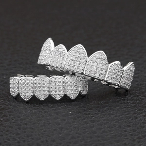 Macro shot of silver-colored hip hop grillz with shimmering cubic zirconia micro-pave