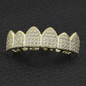 Close-up of hip hop gold-plated grillz featuring six teeth set with sparkling cubic zirconia