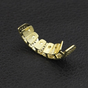 Hip hop gold plated dental grillz with hollow star patterns on premium leather background