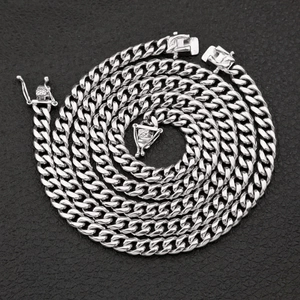 Polished silver Cuban link chain with secure double-locking clasp on black background