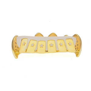 Detail view of gold-plated hip hop bottom grillz with star cutouts and zircon accents