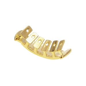 Detailed macro view of gold plated hip hop grillz with star hollowed pattern and AAA zircons