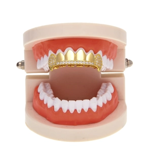 Close-up of gold hip hop grillz with AAA cubic zirconia on a dental model display