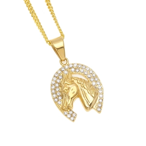 Macro shot of gold-plated horse head pendant featuring iced-out zircon horseshoe frame