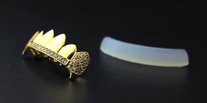 Macro shot of gold-plated hip hop grillz with inlaid AAA zircons and silicone mold
