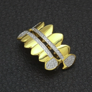Macro shot of gold plated hip hop grillz set with sparkling AAA cubic zirconia micro pave