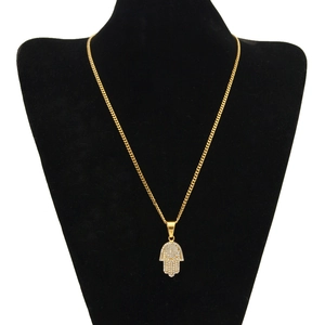 Detailed macro view of gold-plated Hamsa Hand pendant with sparkling zircon micro-pave