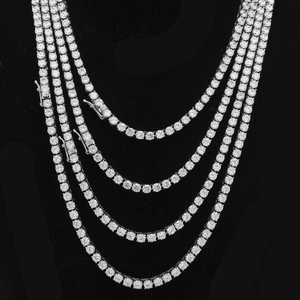 Close-up of 4mm tennis necklaces with silver-finish claw-set stones and secure box clasp