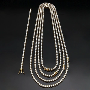 Detail view of gold stainless steel tennis chain and bracelet set with 4mm cubic zirconia