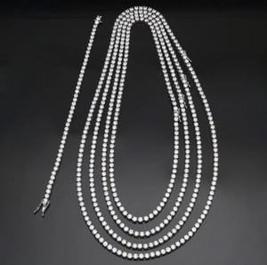 Macro view of 4mm silver tennis necklace set with round-cut cubic zirconia in claw setting