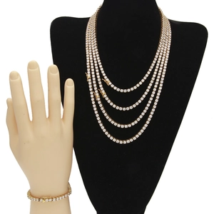 Detail of multi-layered gold tennis chains and bracelet set with 4mm cubic zirconia stones