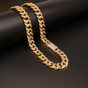 Macro close-up of 20mm gold iced-out Cuban link chain with micro-pave zircons