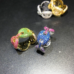 Macro shot of colorful micro-paved zircons on coffee bean hip hop ring in gold finish