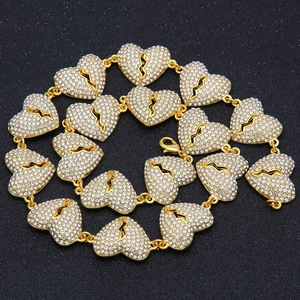 Close-up of hip hop gold chain with iced out broken heart links and white rhinestones