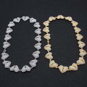 Close-up of gold and silver broken heart hip hop necklaces with micro-pave crystal zircons