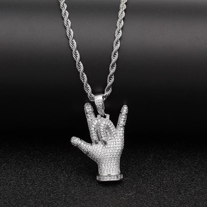 Gros plan du pendentif hip hop argenté avec pierres de zircon sur une chaîne corde