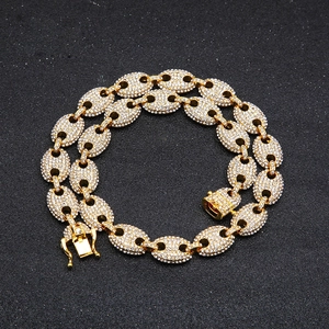Macro shot of hip hop gold mariner link necklace with sparkling iced out cubic zirconia