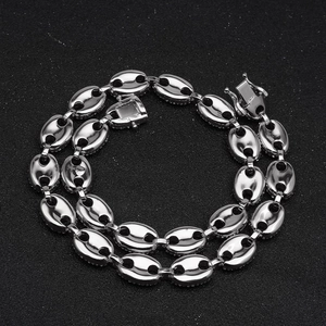 Macro detail of iced-out coffee bean link chain with white zircons and secure clasp