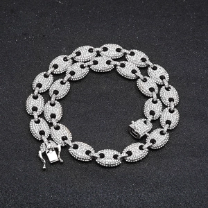 Macro shot of silver hip-hop coffee bean chain with shimmering rhinestones and secure clasp