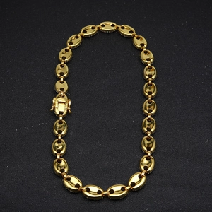 Detailed view of golden coffee bean link chain with a secure spring box clasp closure