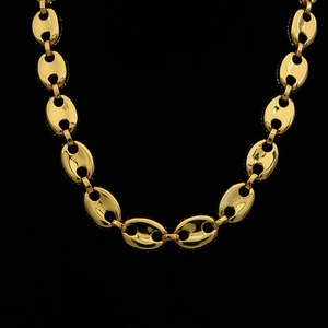 Macro shot of 18K gold plated mariner link chain with polished coffee bean details