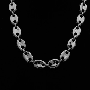 Macro shot of polished silver coffee bean links on a hip hop style necklace