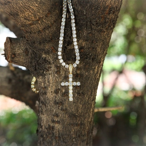 Close-up of gold-plated hip-hop tennis chain with a micro-pave zircon cross pendant