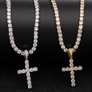 Detailed view of gold and silver hip hop cross pendants with sparkling tennis chains