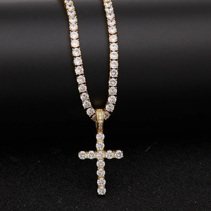 Macro shot of gold hip-hop tennis chain and cross pendant set with micro-pave zircons
