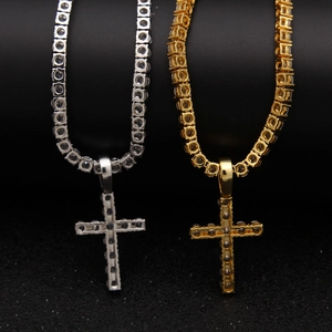 Close-up of gold and silver hip hop tennis chains with iced out cross pendants
