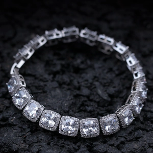 Macro shot of a silver-tone tennis bracelet with square-cut cubic zirconia and micro-pavé