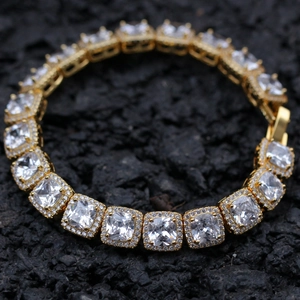 Macro shot of gold-plated tennis bracelet featuring halo square-cut zircon stones