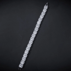 Macro view of iced out silver chain with square cut cubic zirconia stones and detailed setting