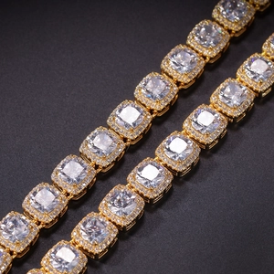 Macro shot of gold hip hop necklace featuring square zircon stones and iced out crystals