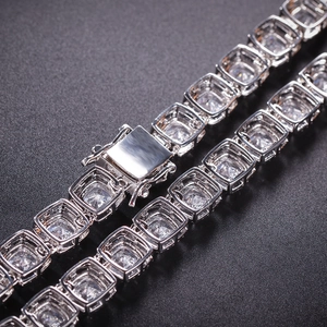 Macro shot of silver hip-hop square tennis chain with halo zircon stones and secure box clasp