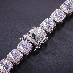 Macro shot of silver hip-hop chain showing square cubic zirconia and secure diamond clasp