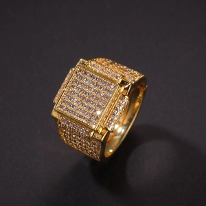 Macro shot of hip hop square gold ring with micro-paved zircon stones on black background
