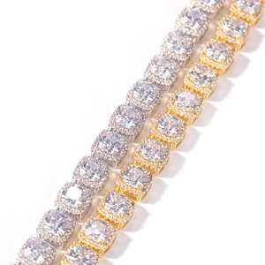 Macro shot of gold and silver hip hop necklaces with square cut cubic zirconia halo links