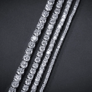Detail of four graduated 2mm tennis bracelets with cubic zirconia on black background