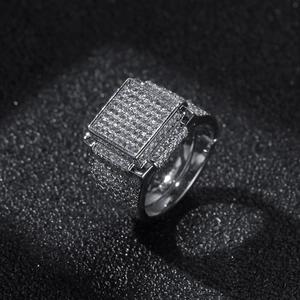 Macro shot of square hip hop ring with paved zircons on polished silver-tone finish