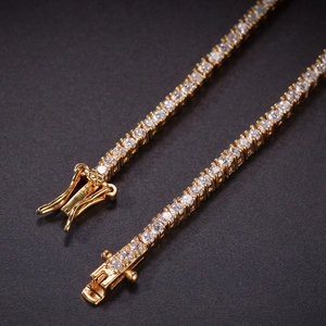 Macro detail of 2mm gold tennis bracelet showing secure clasp and CZ stone setting