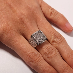 Macro shot of square hip hop ring with dense pavé-set zircons on silver metal