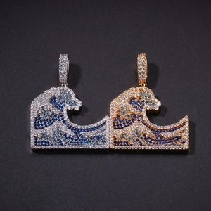 Iced out Great Wave off Kanagawa pendants in gold and silver with blue and white zircons