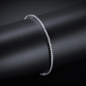 Macro detail of silver tennis bracelet with 2mm round-cut cubic zirconia on black stand